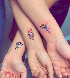 two girls with matching tattoos on their arms