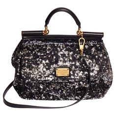 Dolce & Gabbana large black sequins bag. On front of the bag is a gold metal plate with the logo. The interior is crafted of a shiny fabric and has zip pocket attached to it is another gold plate with the logo. The bag comes with a black leather and gold metal chain top handle (5") and a black leather detachable shoulder strap (23.5"). It is in excellent condition and come with a original card, booklet and dust cover. Designer Evening Bag With Sequins, Designer Evening Bags With Sequins, Luxury Black Sequined Bags, Luxury Gold Sequin Bag, Formal Black Bag With Sequins, Black Sequined Bags For Formal Occasions, Designer Sequined Evening Bags, Elegant Sequin Shoulder Bag, Formal Black Sequin Bag