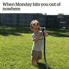 a young boy is playing with a vacuum in the grass while text reads, when monday hits you out of nowhere