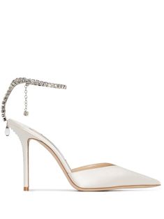 White satin Saeda 100mm crystal-anklet pumps from JIMMY CHOO featuring pointed toe, V-shape vamp, branded insole, crystal-embellished ankle strap and high stiletto heel. | Jimmy Choo Saeda 100mm crystal-anklet pumps Jimmy Choo Saeda, White Stiletto Heels, White Stilettos, Diamond Heels, Jimmy Choo Bridal, Looks Pinterest, Crystal Anklet, White High Heels, Satin Pumps