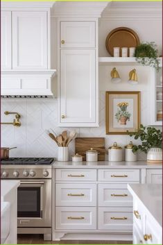 a kitchen with white cabinets and gold accents