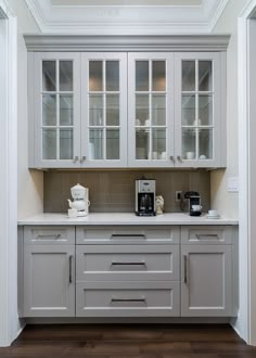 a kitchen with white cabinets and counter tops