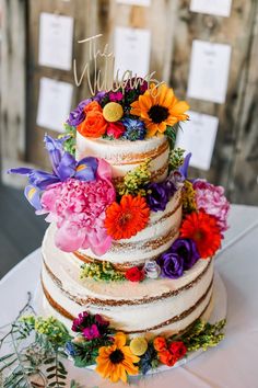 a multi layer cake with flowers on top