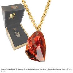 the harry potter necklace is in its box and ready to be worn by someone else