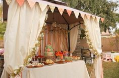 a table covered with food under a canopy