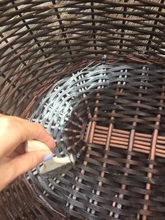 someone is painting the inside of a wicker basket