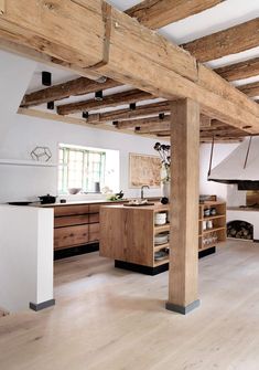 an open kitchen with wooden beams and white walls