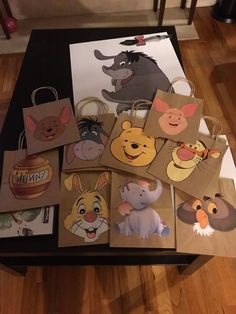 several bags with different cartoon characters on them sitting on a table in front of a coffee table