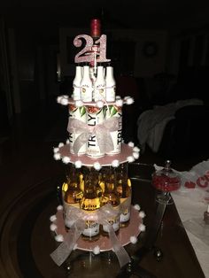 a tiered cake with beer bottles on it