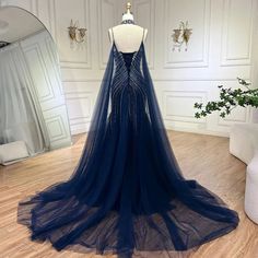 a dress on a mannequin in a room with white walls and wooden floors