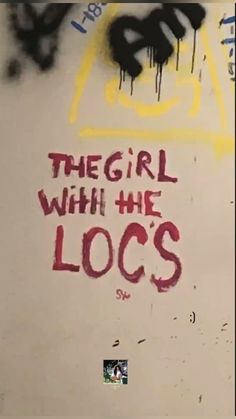 graffiti written on the side of a wall that says, the girl with the locs