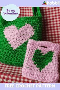 two crocheted purses sitting on top of a red and white checkered table cloth