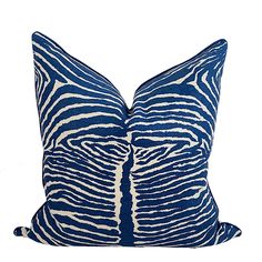 a blue and white zebra print pillow on a white background