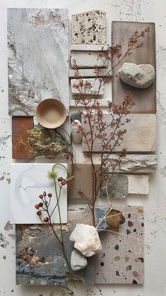 an art work with various materials and flowers on it's side, including rocks