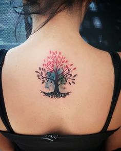 a woman with a tree tattoo on her back