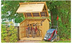 a wooden storage shed with bicycles in it