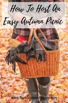 a woman holding a basket full of autumn items with text overlay that reads how to host an easy autumn picnic