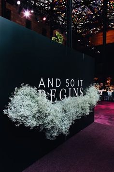 the words and sot begins are displayed on a black wall in front of a purple carpet