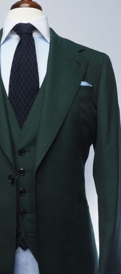 a green suit and tie on a mannequin