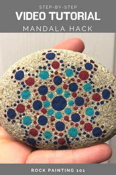 a hand holding a rock that has been painted with dots on it and the text, step - by - step video tutor for mandala hack