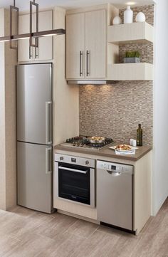 a modern kitchen with stainless steel appliances and wood flooring is pictured in this image