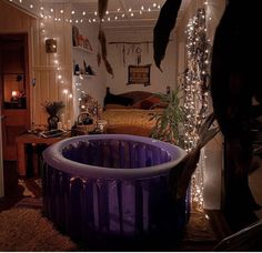 an inflatable bathtub is surrounded by fairy lights