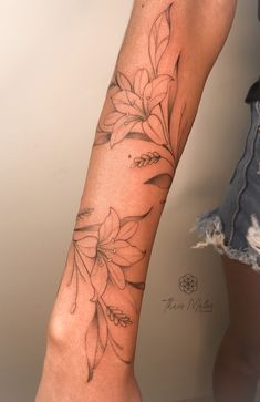 a woman's arm with flowers on it