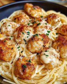 a plate of pasta with scallops and parmesan cheese