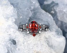 a close up of a ring on top of some rocks with ice in the background