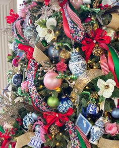 a christmas tree decorated with ornaments and ribbons