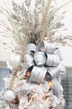 a decorated christmas tree with silver and white decorations