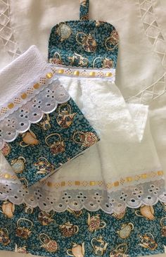 three pieces of clothing sitting on top of a white table cloth covered in doily