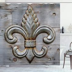 an ornate fleur de lis on the side of a wooden wall