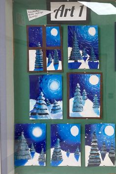 a window display with blue and white christmas trees