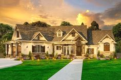 a large white house sitting on top of a lush green field