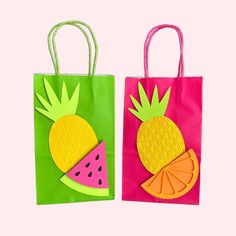 two bags with paper cut out of them, one has a watermelon and the other has a pineapple