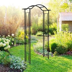 an outdoor garden with flowers and trees in the background, including a tall metal trellis