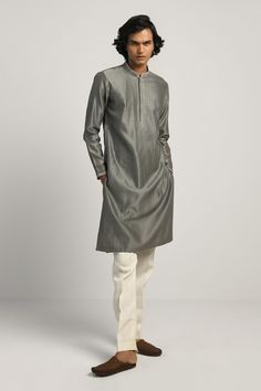 Smoked grey kurta with hand embroidery at band collar, concealed placket and full sleeves.
Component: 1
Embroidered
Neckline: Band Collar
Sleeve Length: Full
Fabric: Chanderi
Color: Grey
Concealed placket
Side pockets
Note: The pant worn by the model is not for sale - Aza Fashions Gray Straight Kurta For Festive Occasions, Traditional Gray Kurta For Diwali, Traditional Gray Kurta For Eid, Festive Gray Embroidered Kurta, Festive Embroidered Gray Kurta, Fitted Gray Kurta For Eid, Gray Fitted Kurta For Eid, Festive Long Sleeve Gray Kurta, Gray Embroidered Kurta For Eid