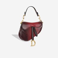 The cherished and emblematic Saddle Bag from Dior makes a surprising comeback in 2018. The bag was reinvented in a few different sizes and more colours than ever before, and this particular edition is created in python exotic leather and a rich maroon red. With a bag so special it’s no wonder the Saddle is on every girl’s mind. It features a gorgeous suede lining and showcases a single storage compartment. Bursting with class and flair, the Dior Saddle Bag is great for adding the finishing touch to your outfit. SPL Exterior Maroon ombre python leather Mini size Gold tone hardware Hanging D charm Attached shoulder strap Rear slip pocket Hidden magnetic closure Excellent condition - some wear to scales on handle Interior Red suede interior Single storage compartment Immaculate condition Sold Birthday 28, Mini Saddle Bag, Luxurious Fashion, Dior Saddle, Favorite Handbags, Handbags Affordable, Maroon Red, Pretty Bags, Red Suede