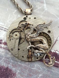 Griffin Steampunk Necklace  #Steampunk #newfromold #ilm #vintagejewelry #industrialdesign #steampunkart #neovictorian #handmade #steampunkjewelry #timlesstreasure Steampunk Bronze Pendant Necklace, Steampunk Silver Brass Necklaces, Steampunk Silver Pocket Watch With Locket, Steampunk Silver-color Brass Necklaces, Steampunk Bronze Engraved Jewelry, Bronze Steampunk Jewelry With Engraving, Silver Steampunk Pocket Watch With Locket, Steampunk Medallion Engraved Jewelry, Silver Steampunk Brass Necklaces