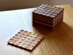 four pieces of wood sitting on top of a wooden table next to another piece of paper