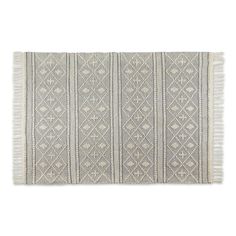 a gray and white rug with fringes on the bottom, in front of a white background