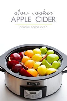 the slow cooker has apples and oranges in it