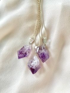 **Each piece in my shop, I personally create and photograph. (All photos are property of The Cord Gallery LLC) Thank you for supporting my small business. These stunning necklaces are made with Raw Amethyst Stones. Freeform, rough cut and very natural looking! Each stone has a slight ombre effect from lighter to darker purple tones - so stunning! {Stones measure approximately 1 inch tall - not including connector bail}Hangs on your choice of chain:Sterling Silver Link Sterling Silver BallSterlin Personalized Purple Pendant Necklace, Spiritual Amethyst Crystal Necklace With Raw Stone, Amethyst Raw Stone Necklace For Healing, Purple Amethyst Necklace With Raw Stone, Bohemian Amethyst Crystal Necklace With Raw Stone, Purple Stone Necklace, Amethyst Pendant Necklace, Purple Raw Stone Crystal Pendant Necklace, Amethyst Necklace Pendant