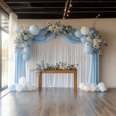 a white and blue decorated stage with balloons