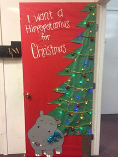 a door decorated with a christmas tree and hippo