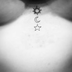 a black and white photo of the back of a woman's neck with two stars and a crescent tattoo