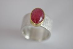 925 sterling silver with a beautiful shining ruby, set in 750 gold, partly polished, Dimensions of the ring band: approx. 10.4 mm wide, 1.7 mm thick Stone size: 13 x 9 mm Ruby shows natural inclusions Weight 14.6g size 55.5 - 56 / 17.7 / 7.75 Expandable up to size 57 Unique sterling silver ring "Blickfang 42" by Frank Schwope Unique jewellery, Ruby, Gold, Ring, Goldsmith work, Unique jewellery, Noble, Ruby red, Red, Unique Jewellery Jewellery Ruby, Ruby Gold Ring, Ruby Set, Ruby Red, Solitaire Ring, Sterling Silver Ring, Gold Ring, Favorite Jewelry, Band Rings