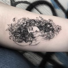 a woman's head with flowers and leaves on her left arm, in black ink