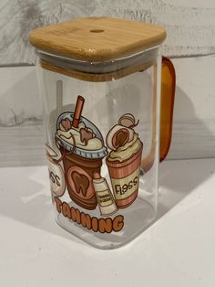 a plastic container with a wooden lid and an image of two iced coffees on it